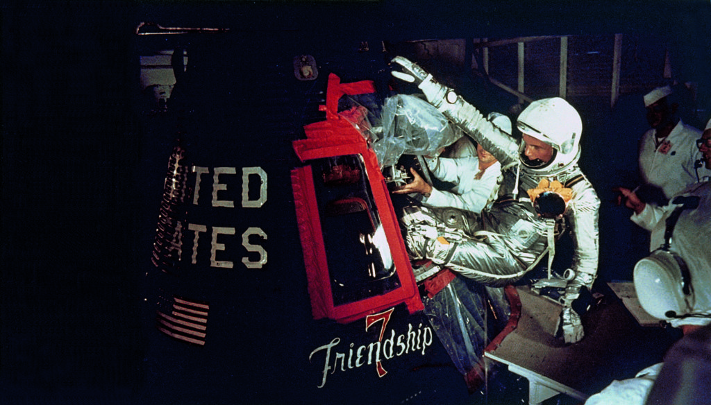 Overall view of astronaut John Glenn, Jr., as he enters into the spacecraft Friendship 7 prior to MA-6 launch operations at Launch Complex 14. Astronaut Glenn is entering his spacecraft to begin the first American manned Earth orbital mission.